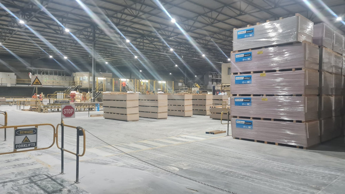 Gyproc board stacked in the Saint-Gobain warehouse under a run of LED high bays