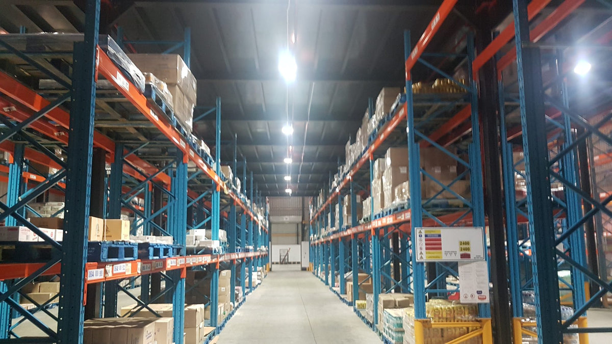Racked cold store aisle at Vector Logistics Cape Town lit by LED linear high bays